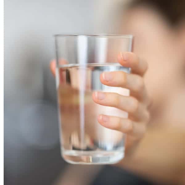 A Girl With A Glass of Water in hand