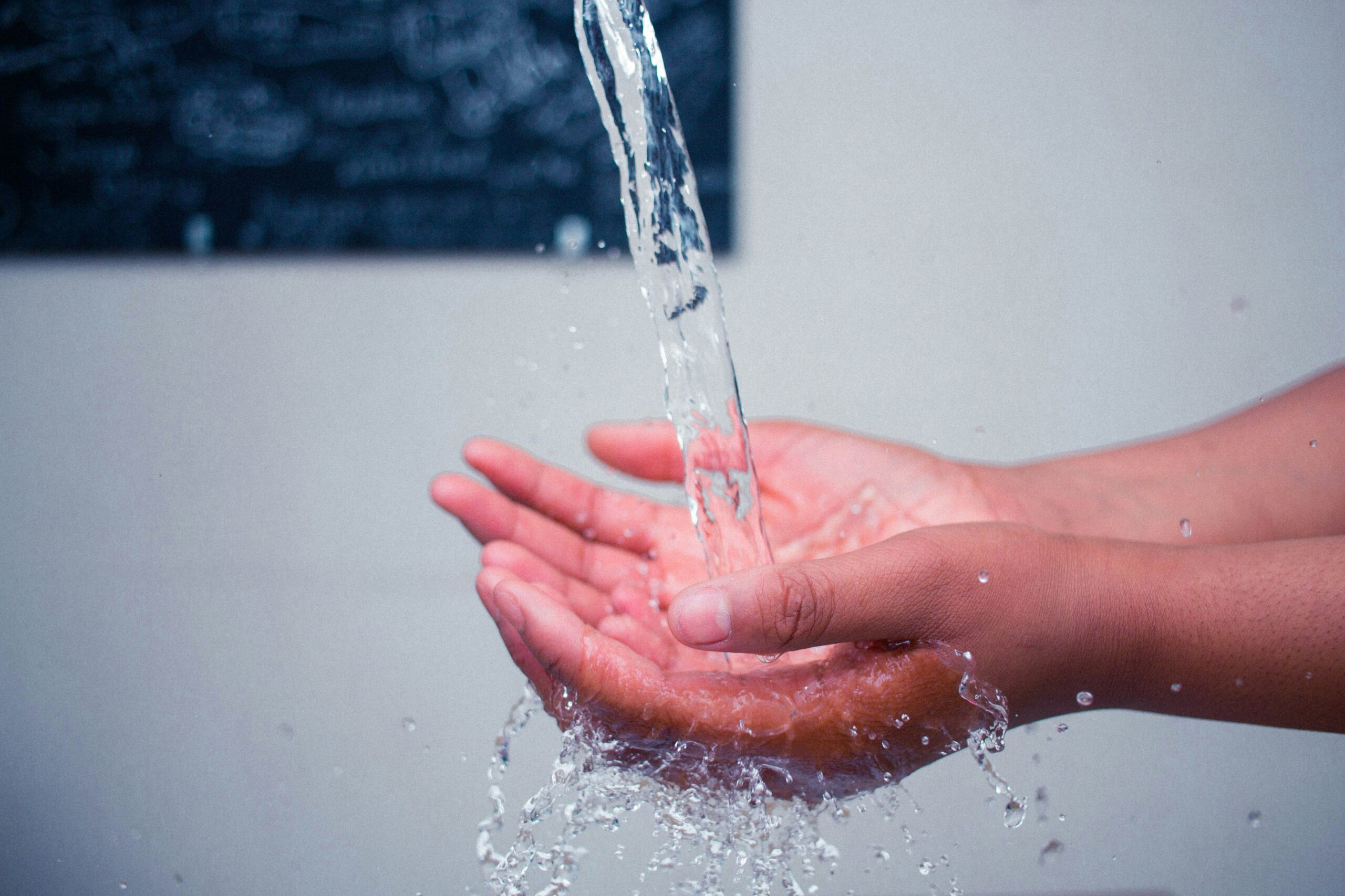 Water flowing from faucet onto hands