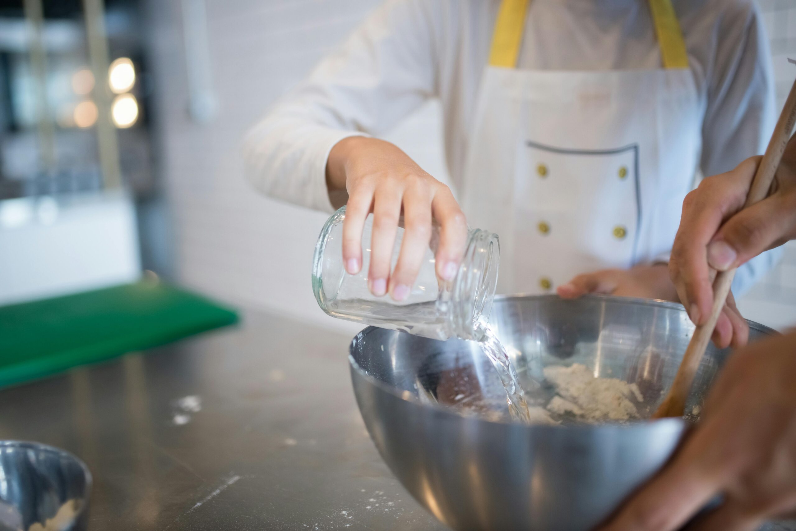 Woman Pouring water into Bowl