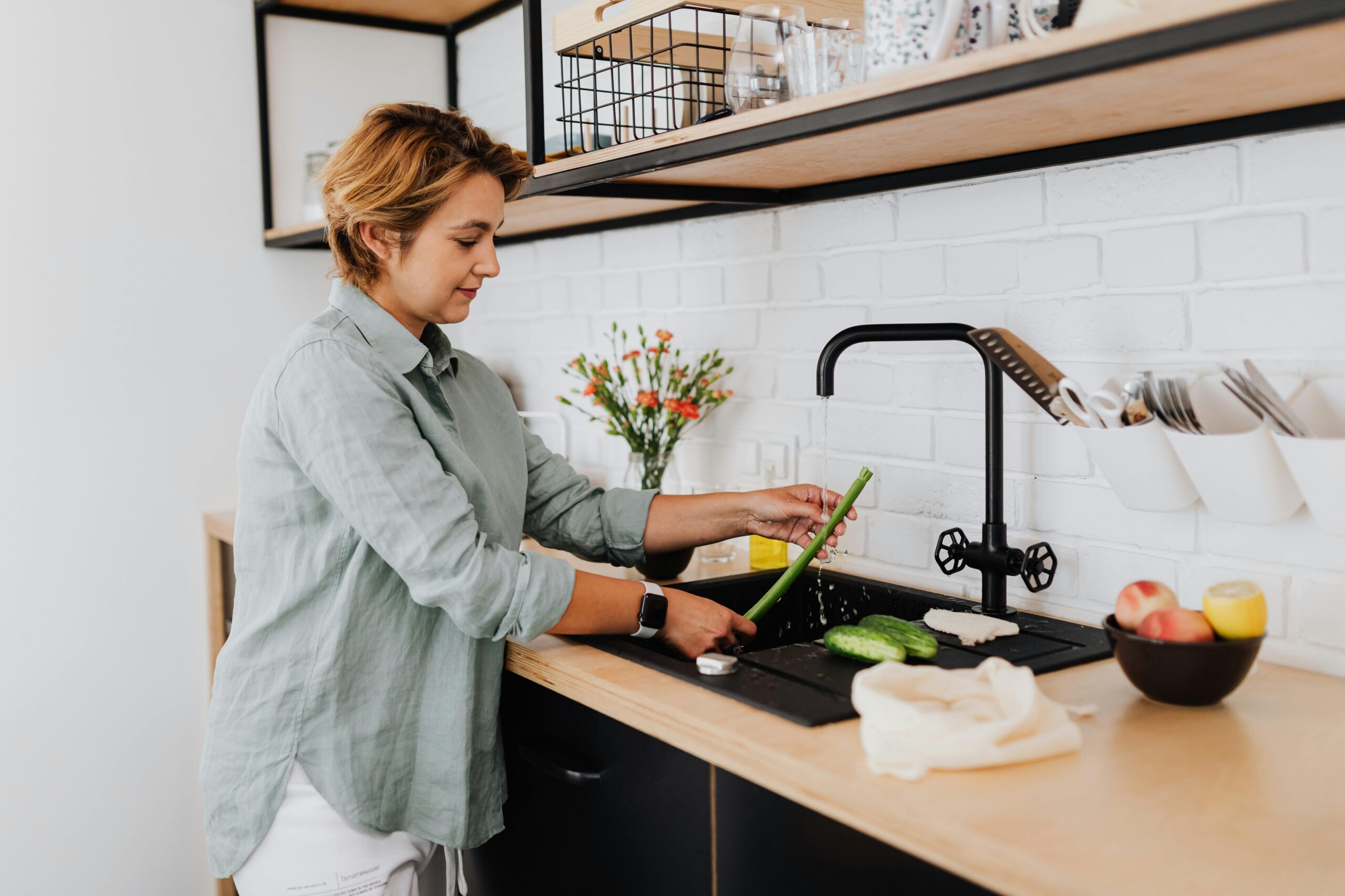 Woman washing celery